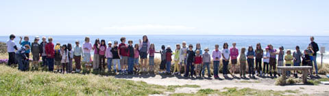 Children lined up to show length of gray whale